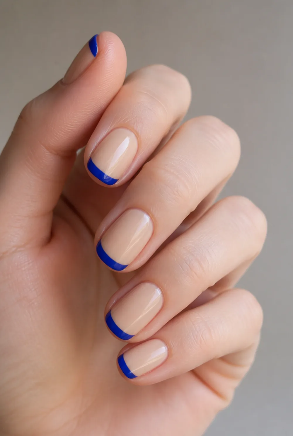 electric blue energy french tip nails nail art on fair skin, short length