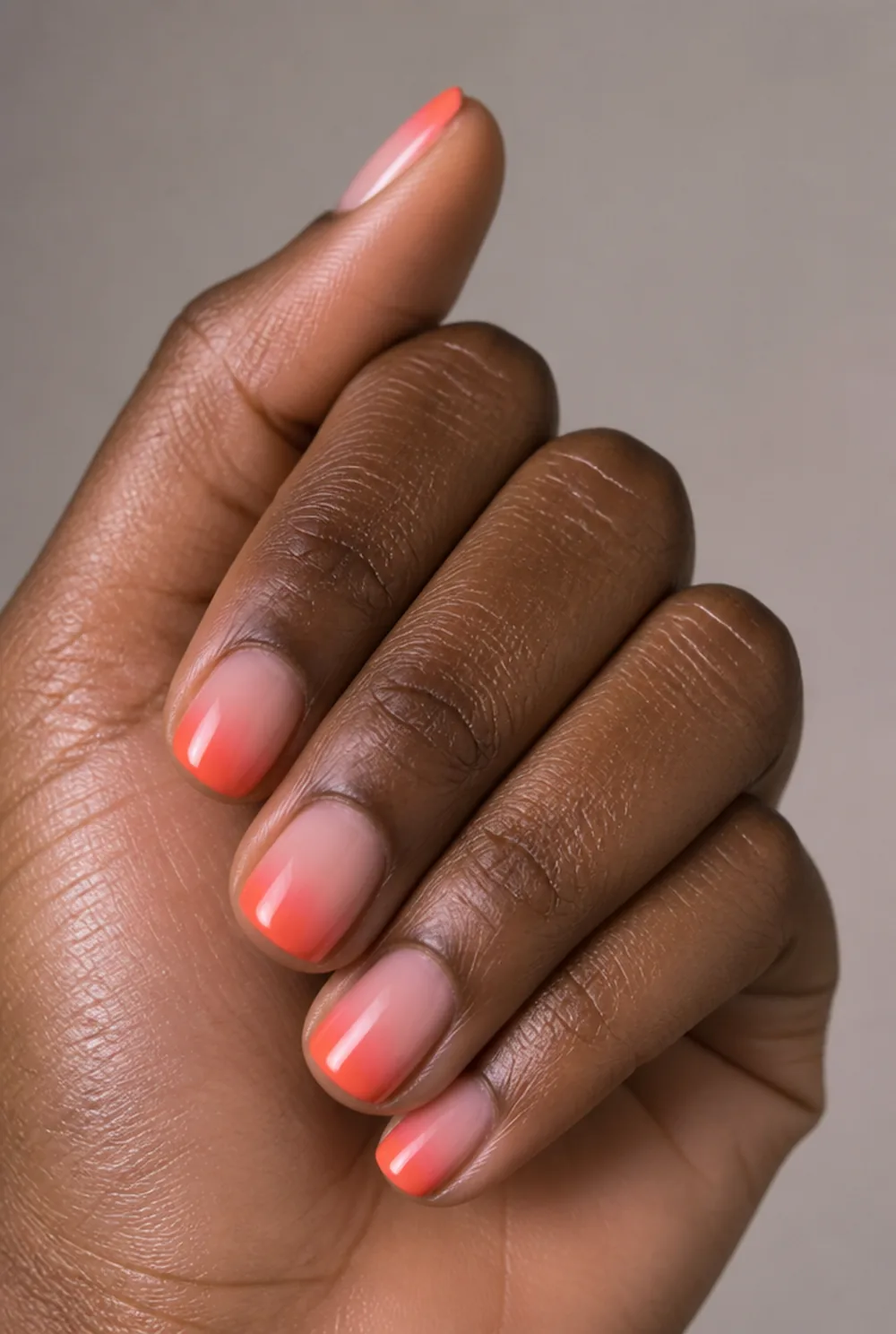 coral sunset french tip nails nail art on deep brown skin