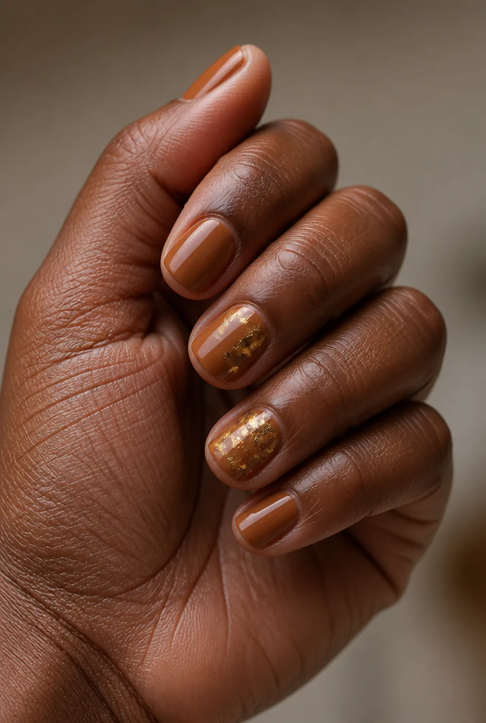 toffee with gold fleck nail art on deep brown skin - PolishedAndPrettyNails.com toffee with gold fleck nail art on deep brown skin