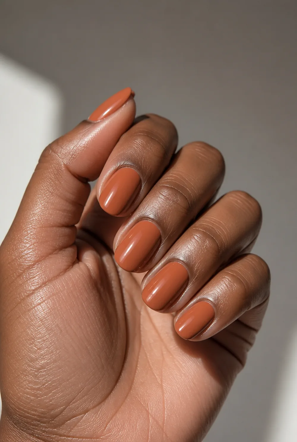 terracotta short almond nail art on deep brown skin - PolishedAndPrettyNails.com terracotta short almond nail art on deep brown skin