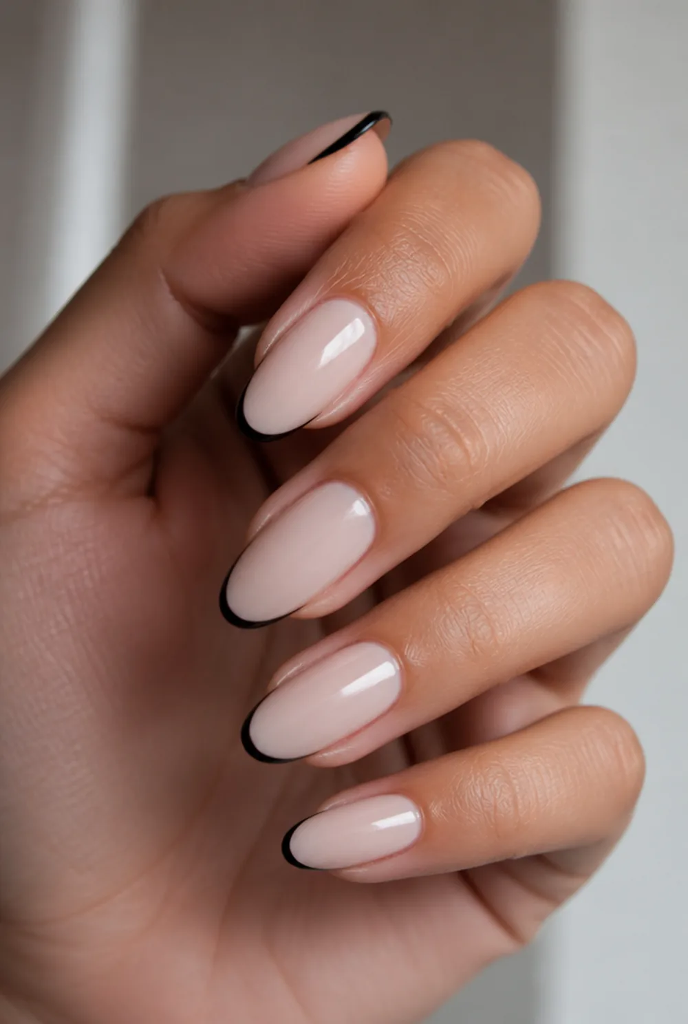 black french on milky base nail art on olive skin, long length