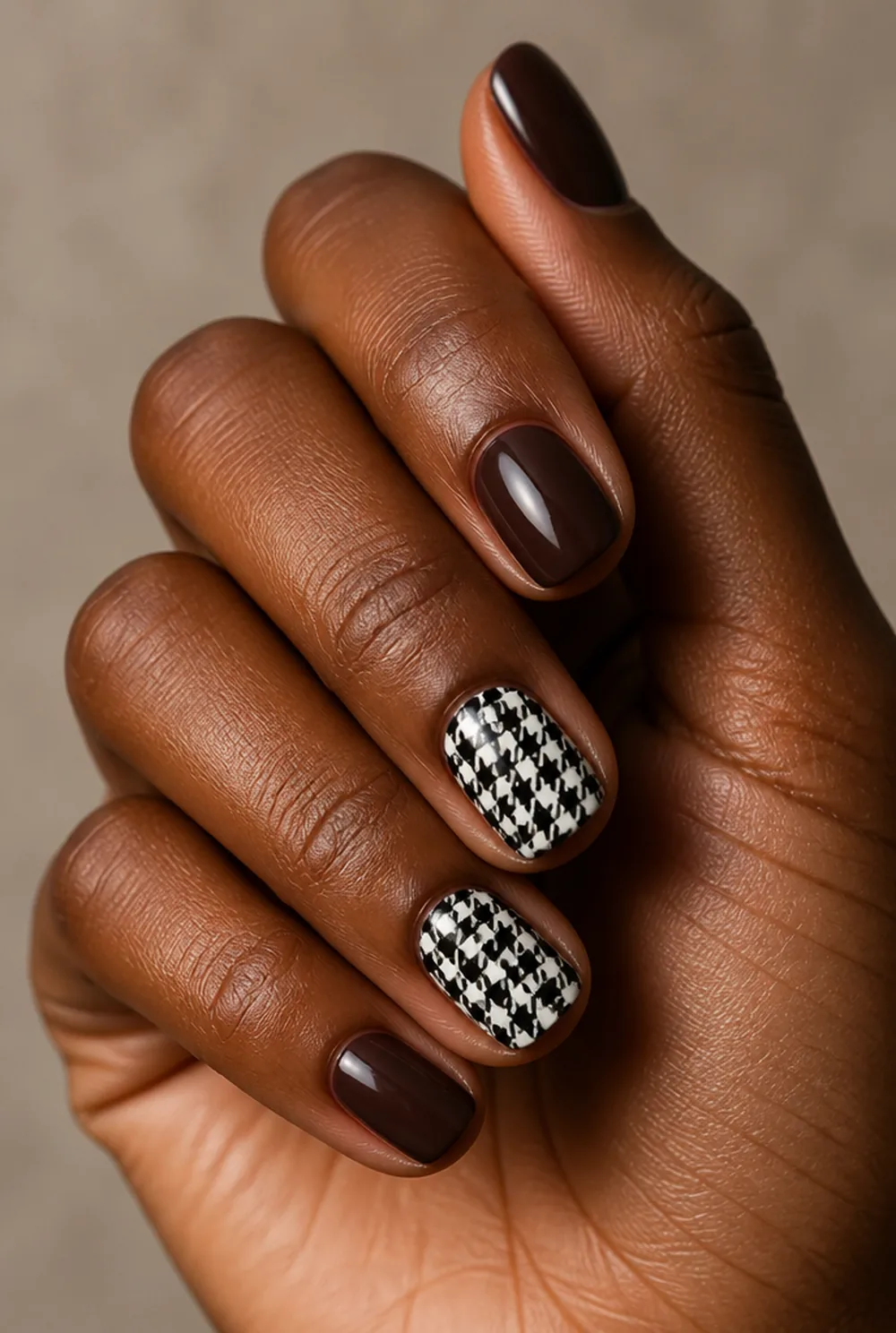 houndstooth accent nail art on deep brown skin