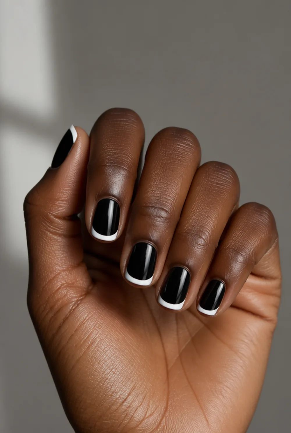 white french on black base nail art on deep brown skin