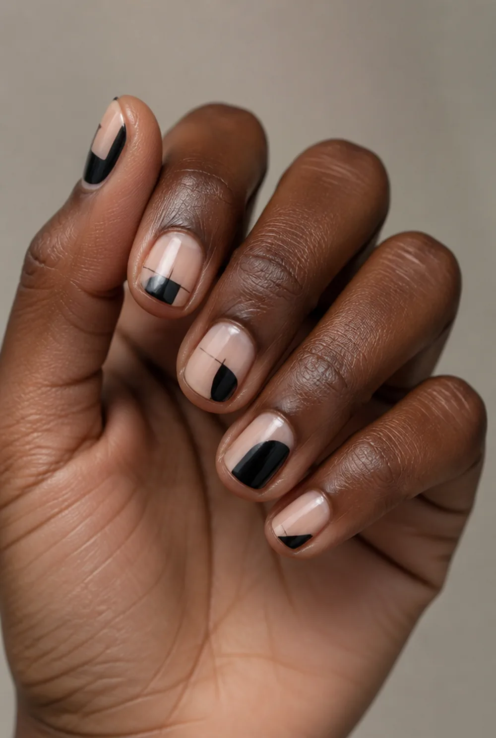 black negative space nail art on deep brown skin