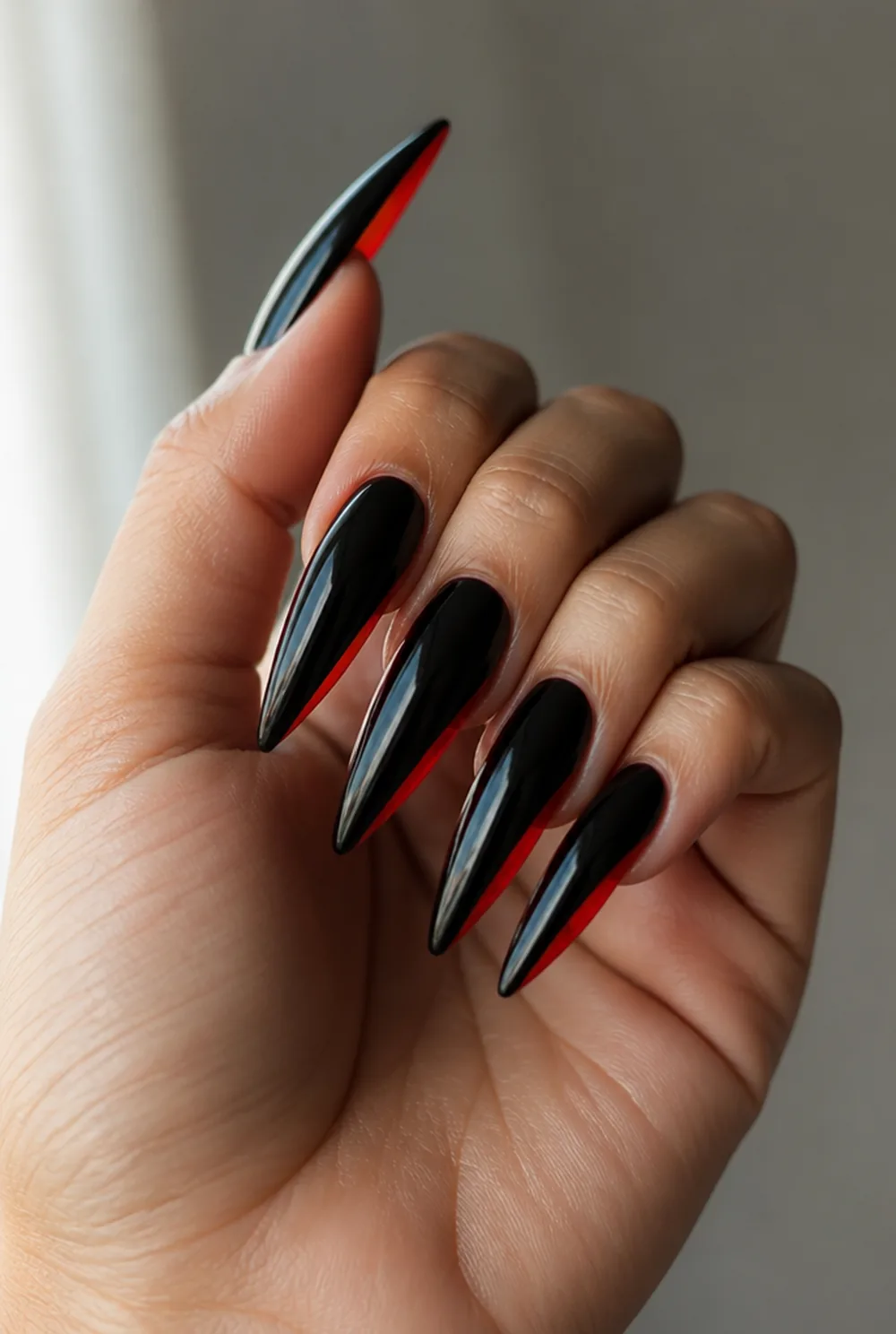 red-bottom black nail art on olive skin, long length