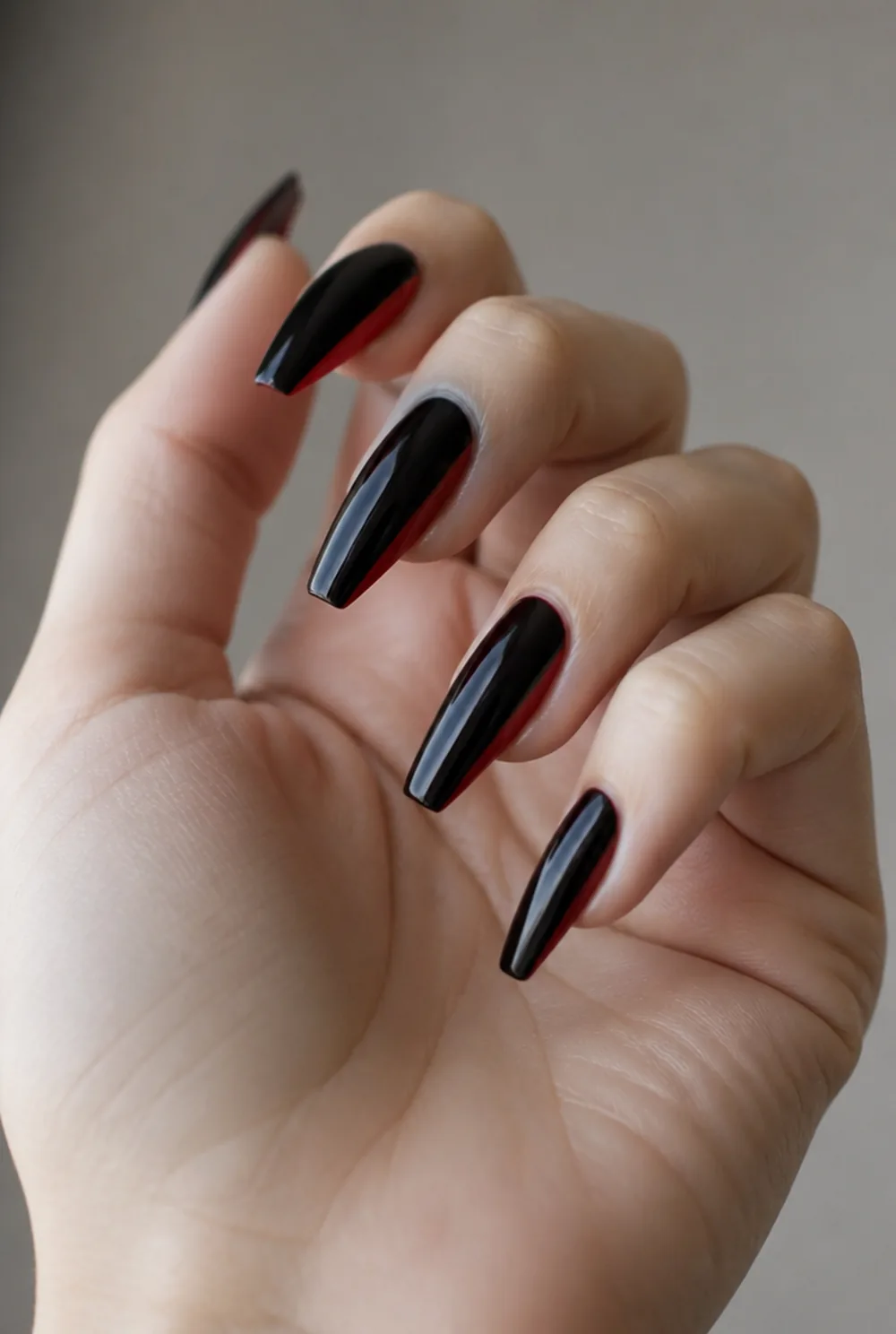red-bottom black nail art on fair skin, short length