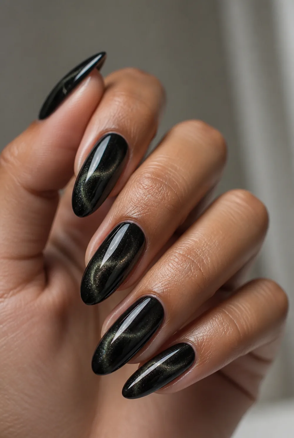 black cat eye nail art on olive skin, long length