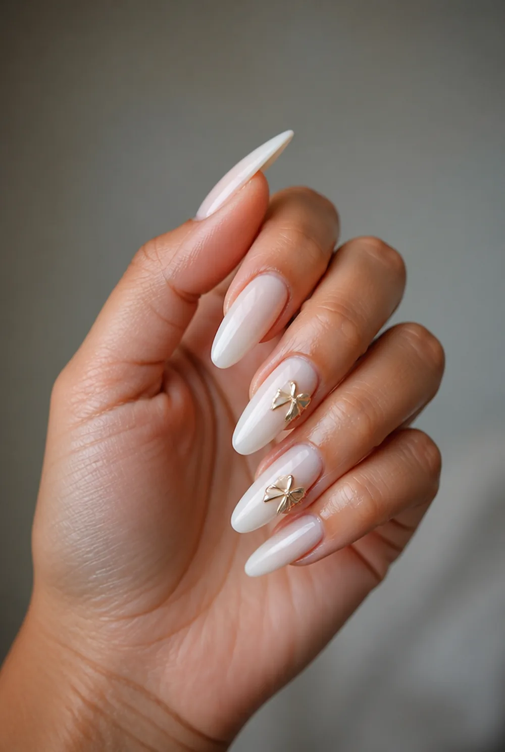 gold bow accents nail art on olive skin long length - PolishedAndPrettyNails.com gold bow accents nail art on olive skin, long length