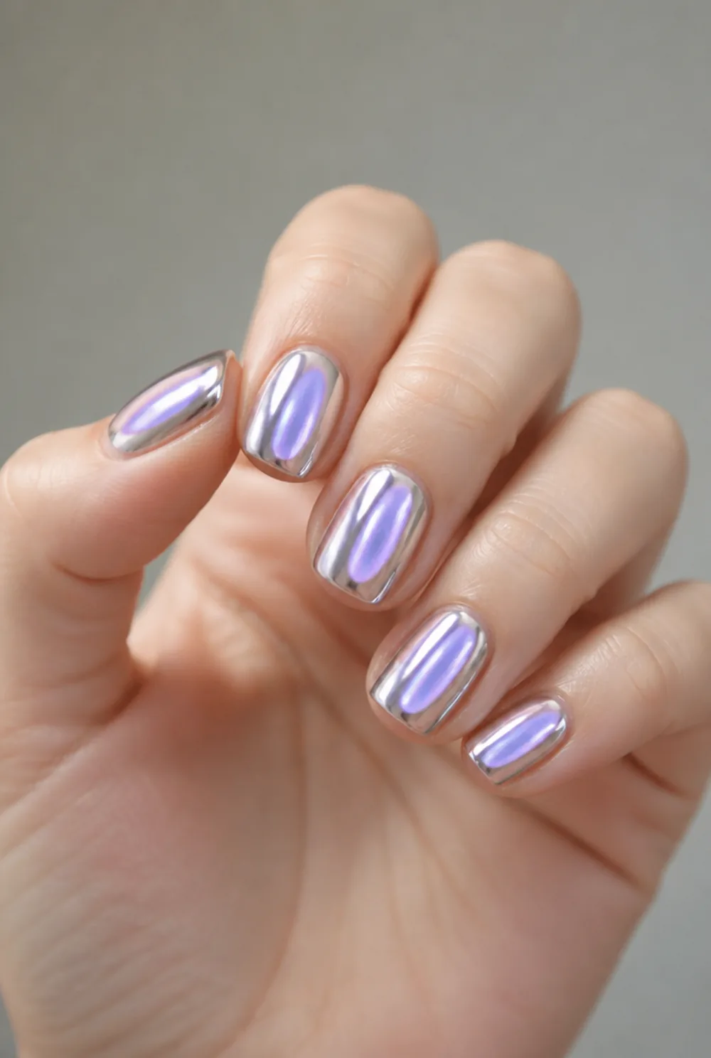 aura chrome nail art on fair skin, short length