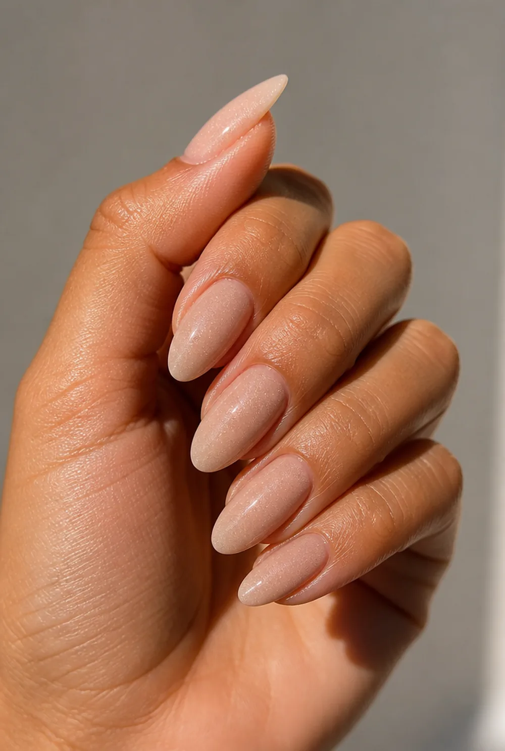 barely-there shimmer nail art on olive skin, long length