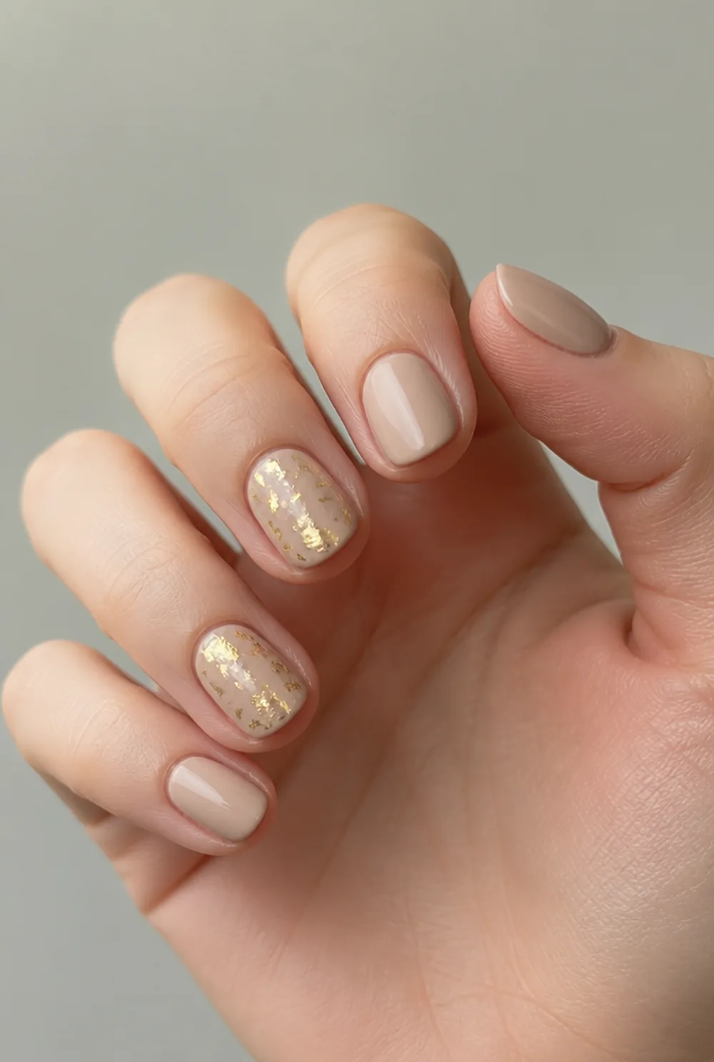 gold fleck accent nail art on fair skin, short length