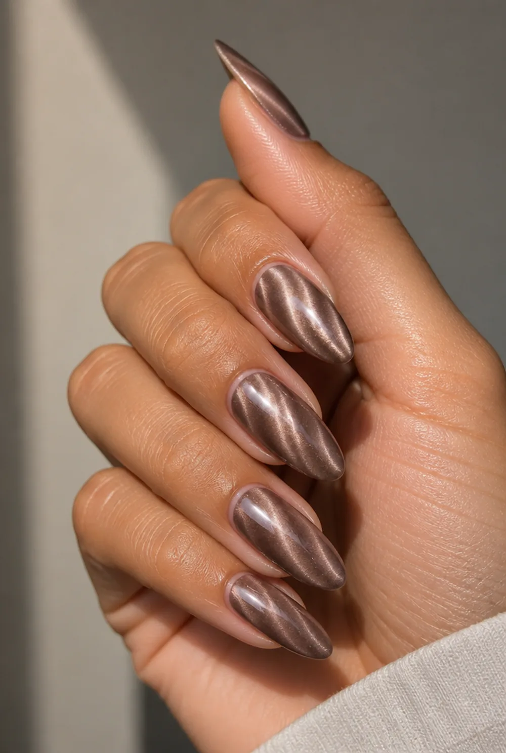 taupe cat eye nail art on olive skin, long length