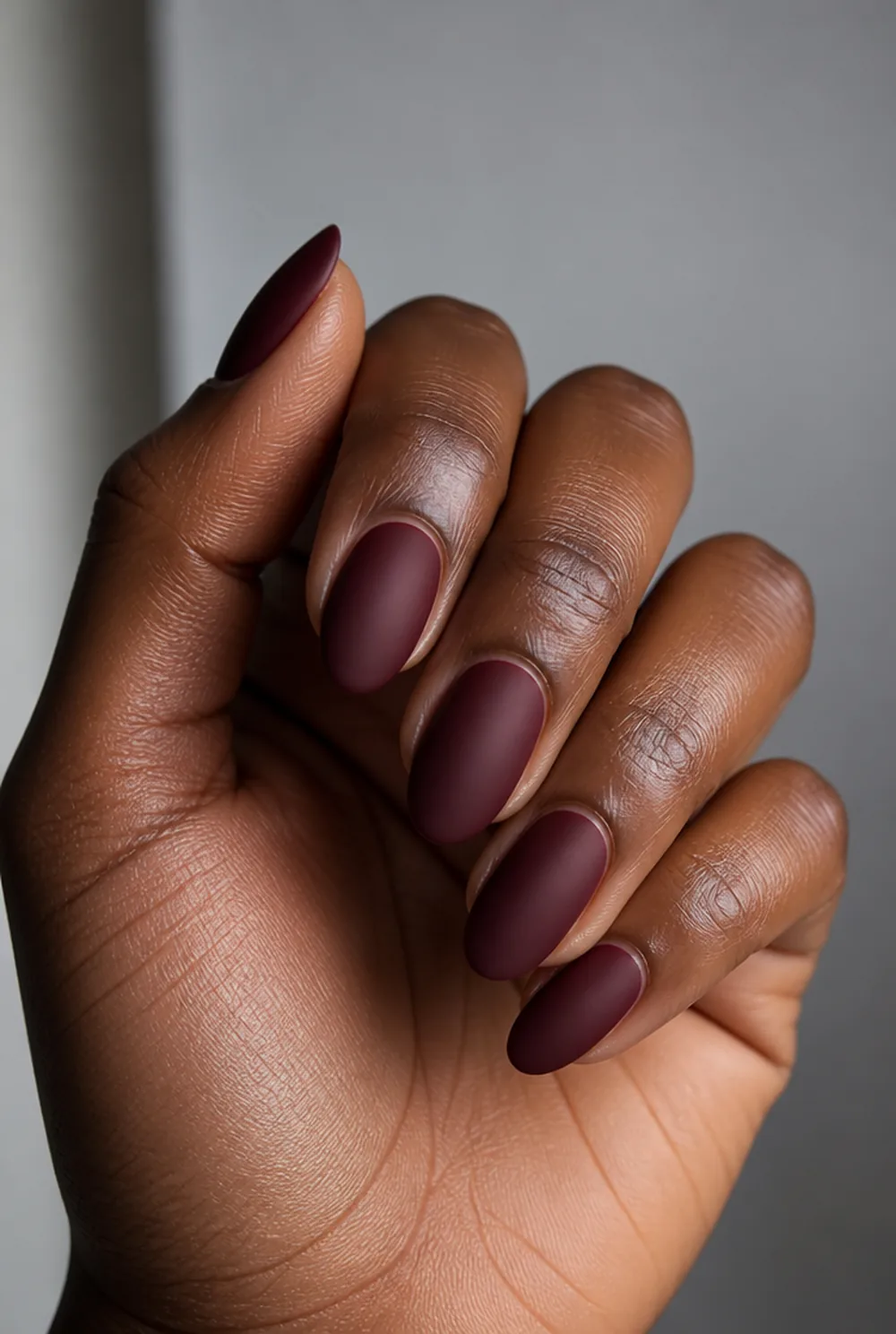deep wine almond nail art on deep brown skin