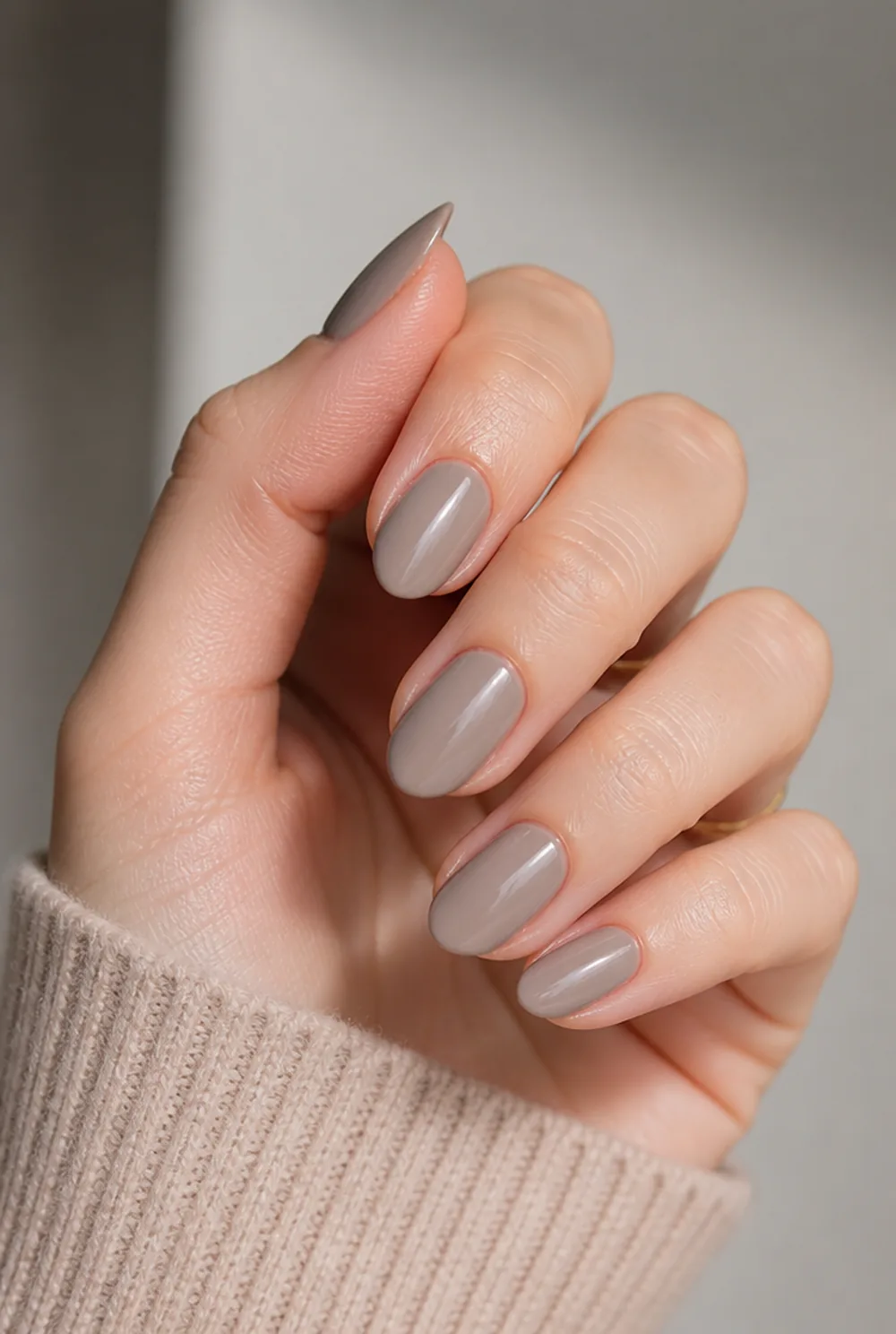glossy greige nail art on fair skin, short length