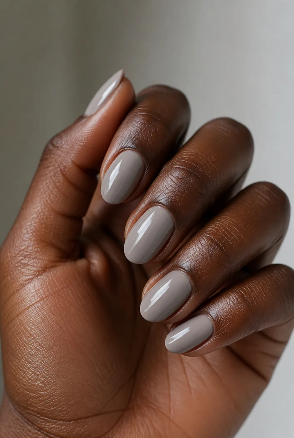 glossy greige nail art on deep brown skin
