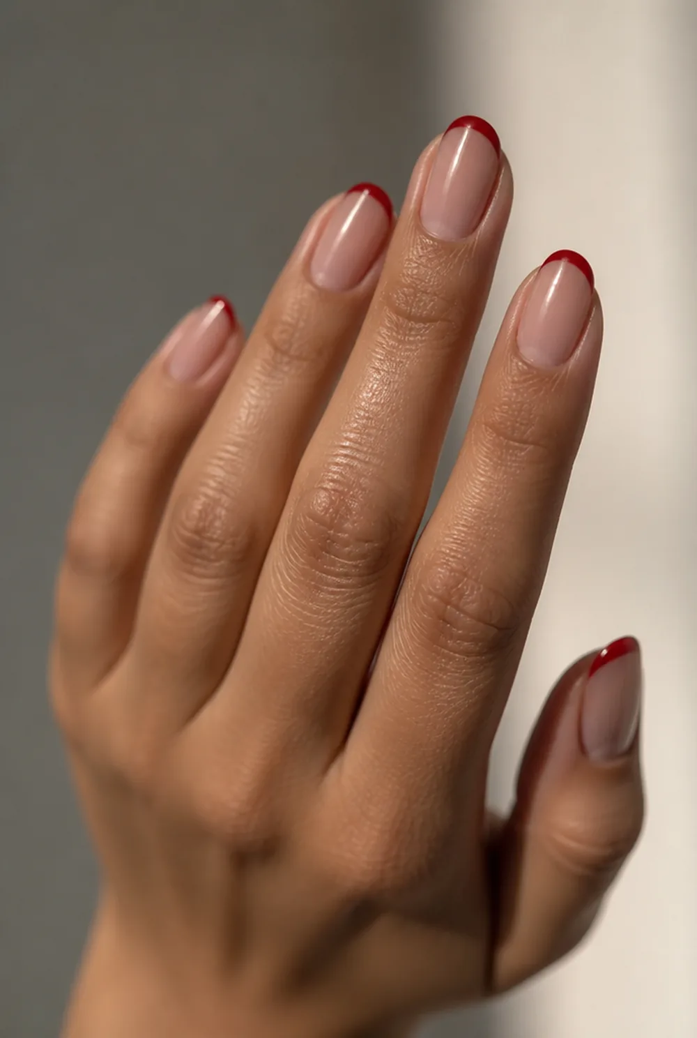 red micro french nail art on olive skin, long length
