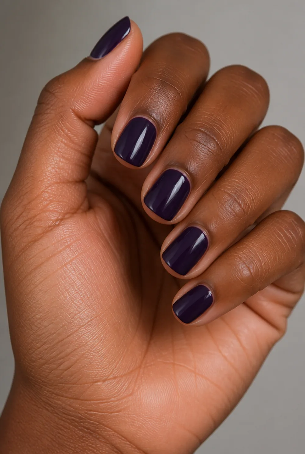 aubergine gloss nail art on deep brown skin