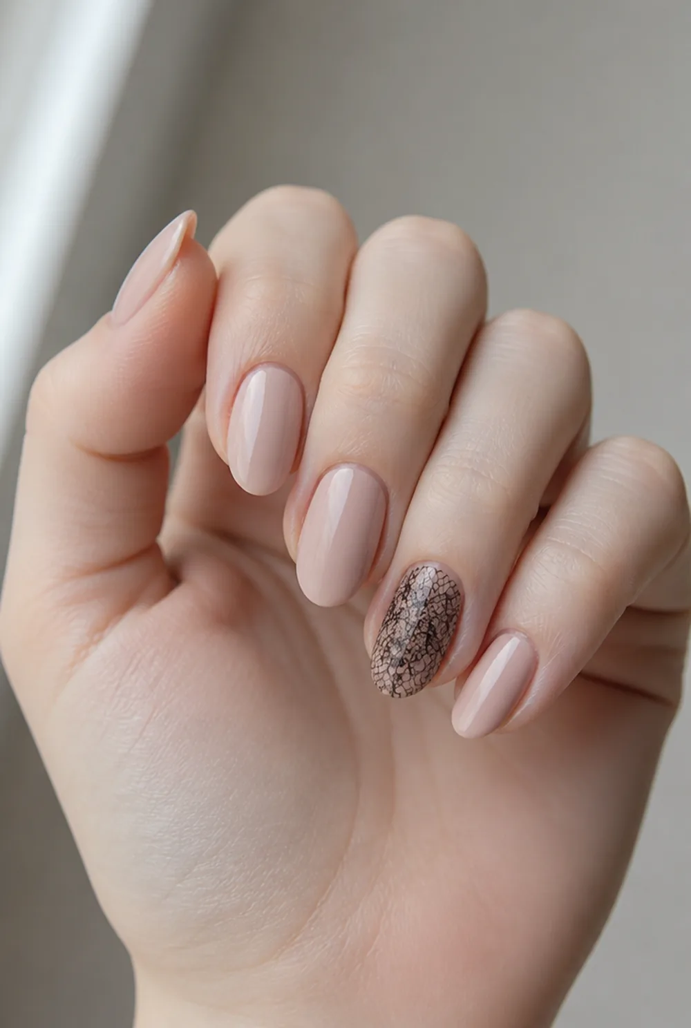 black lace accent nail art on fair skin, short length