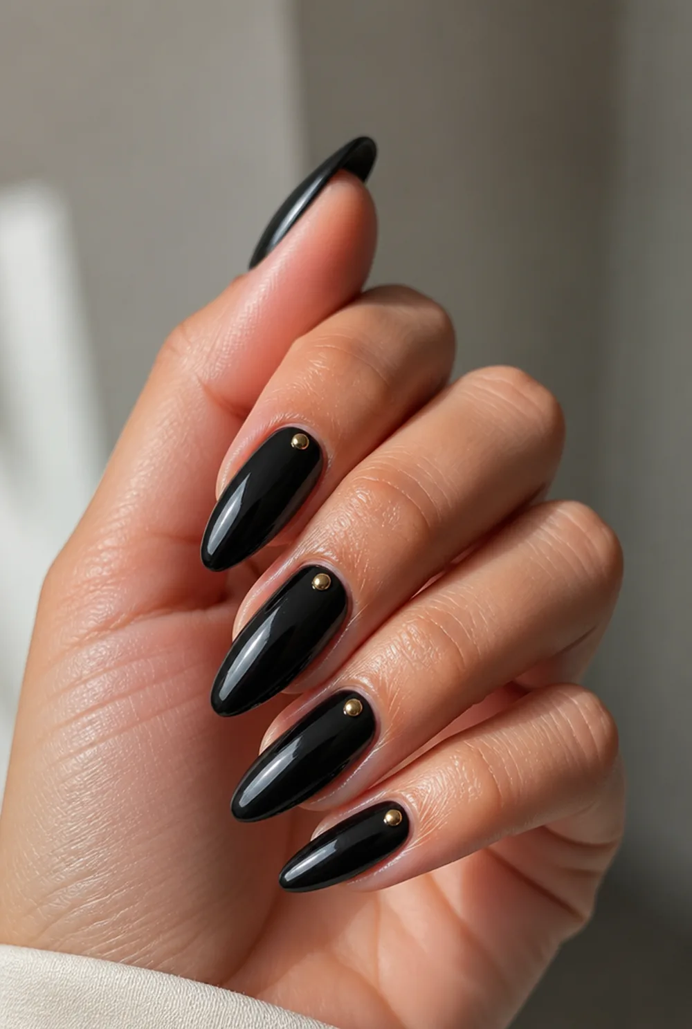 onyx with gold studs nail art on olive skin, long length