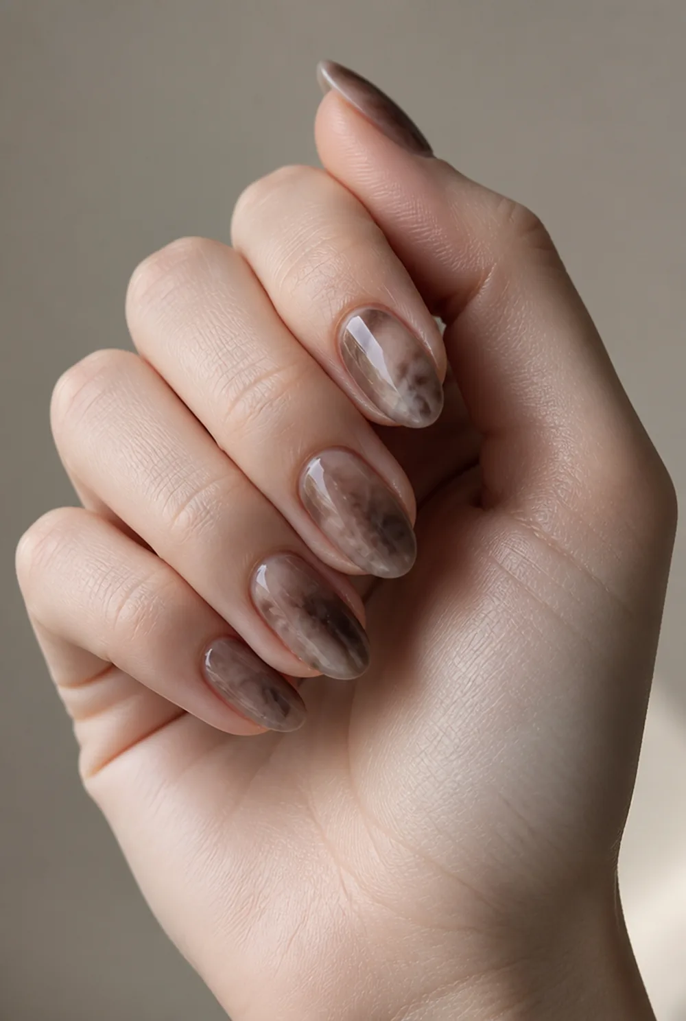 smoky quartz marble nail art on fair skin, short length