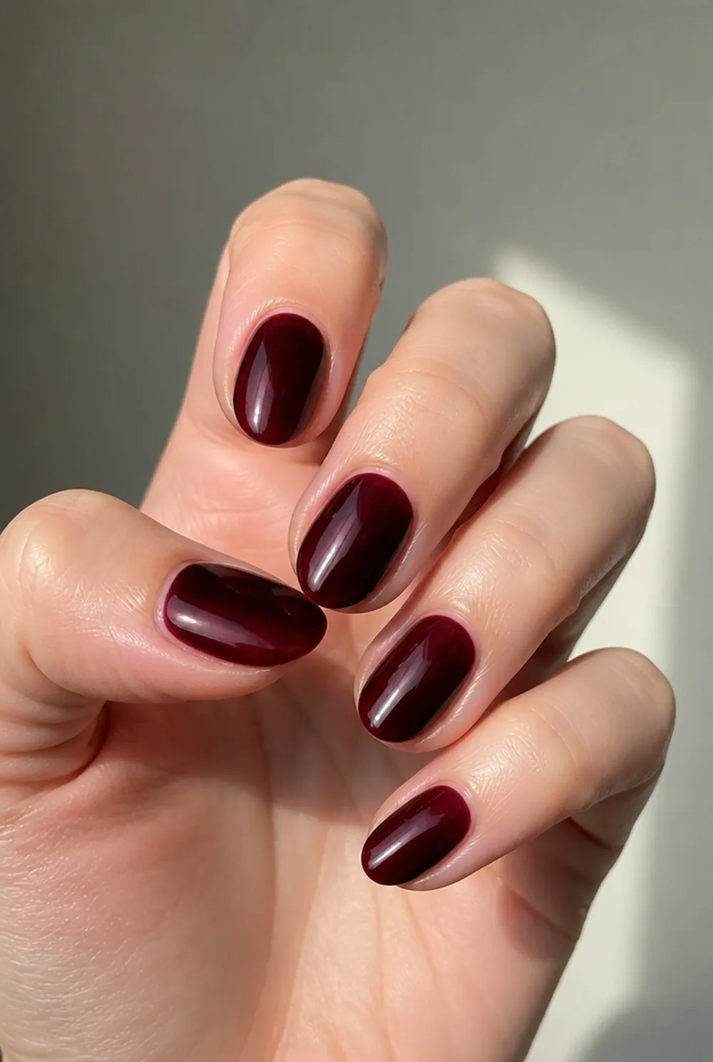black cherry glass nail art on fair skin, short length