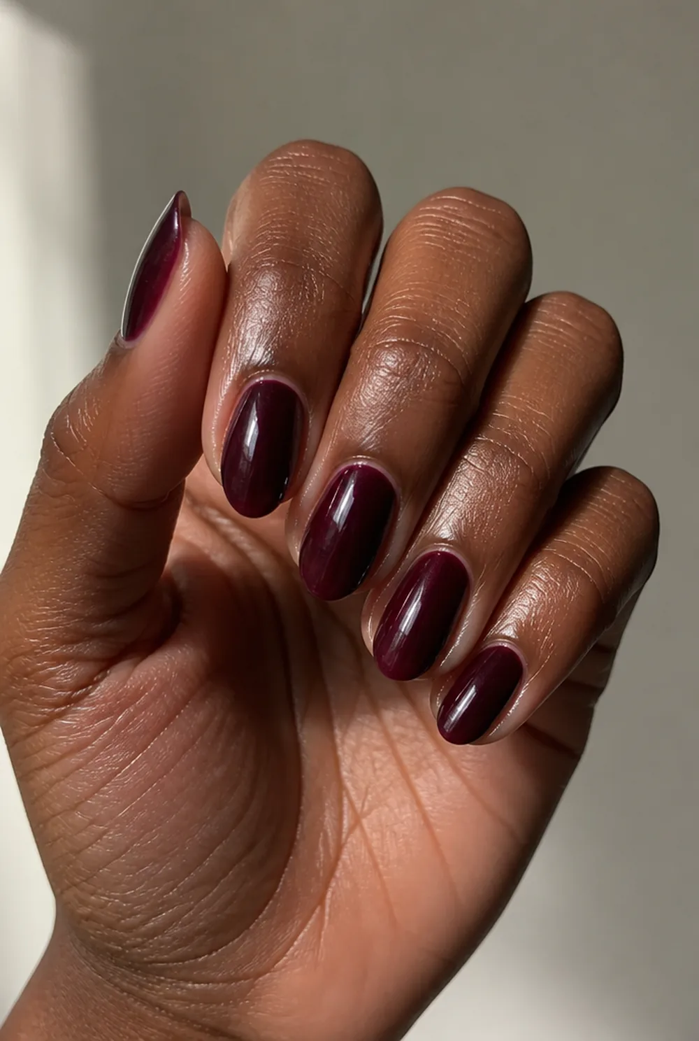 black cherry glass nail art on deep brown skin