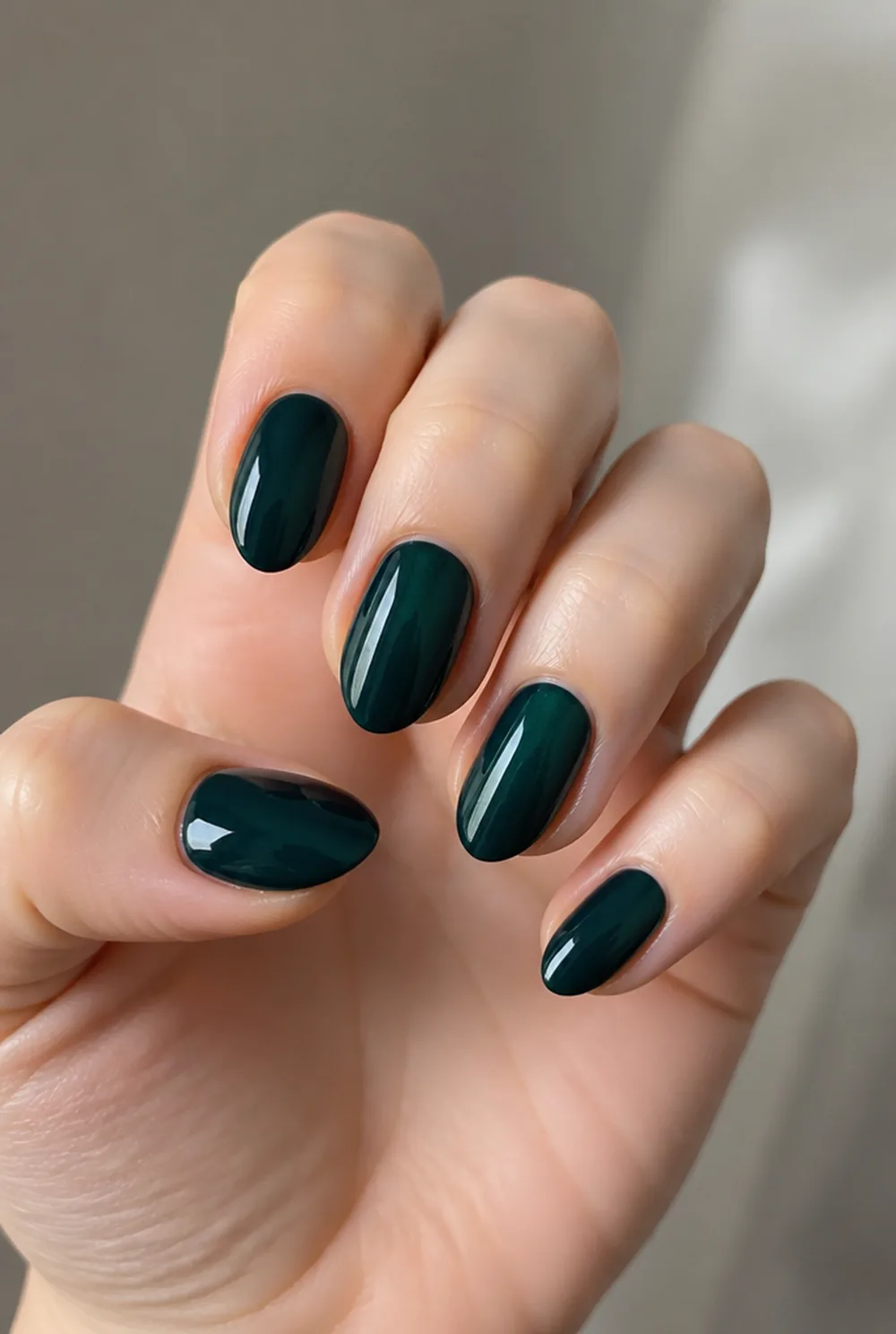 blackened emerald nail art on fair skin, short length