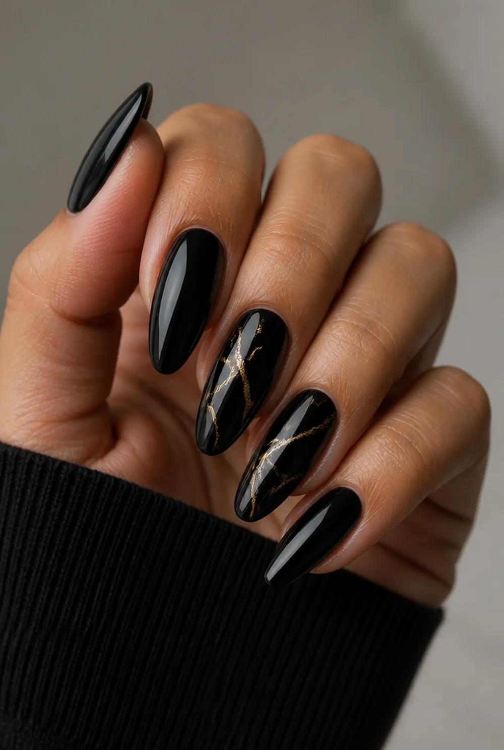 gold-vein black marble nail art on olive skin, long length