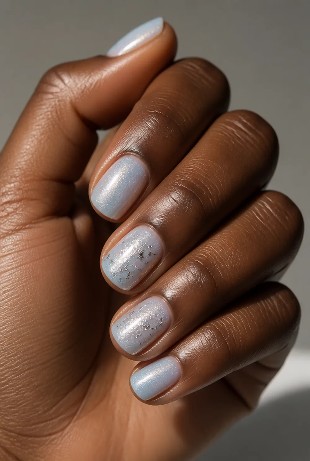 elsa ice shimmer nail art on deep brown skin