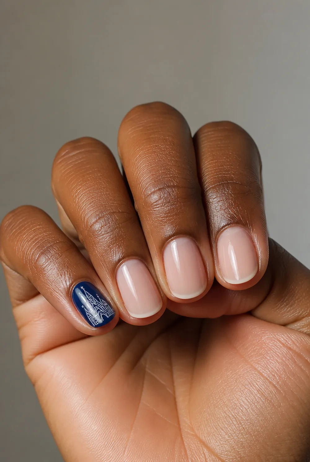 castle silhouette pinky nail art on deep brown skin
