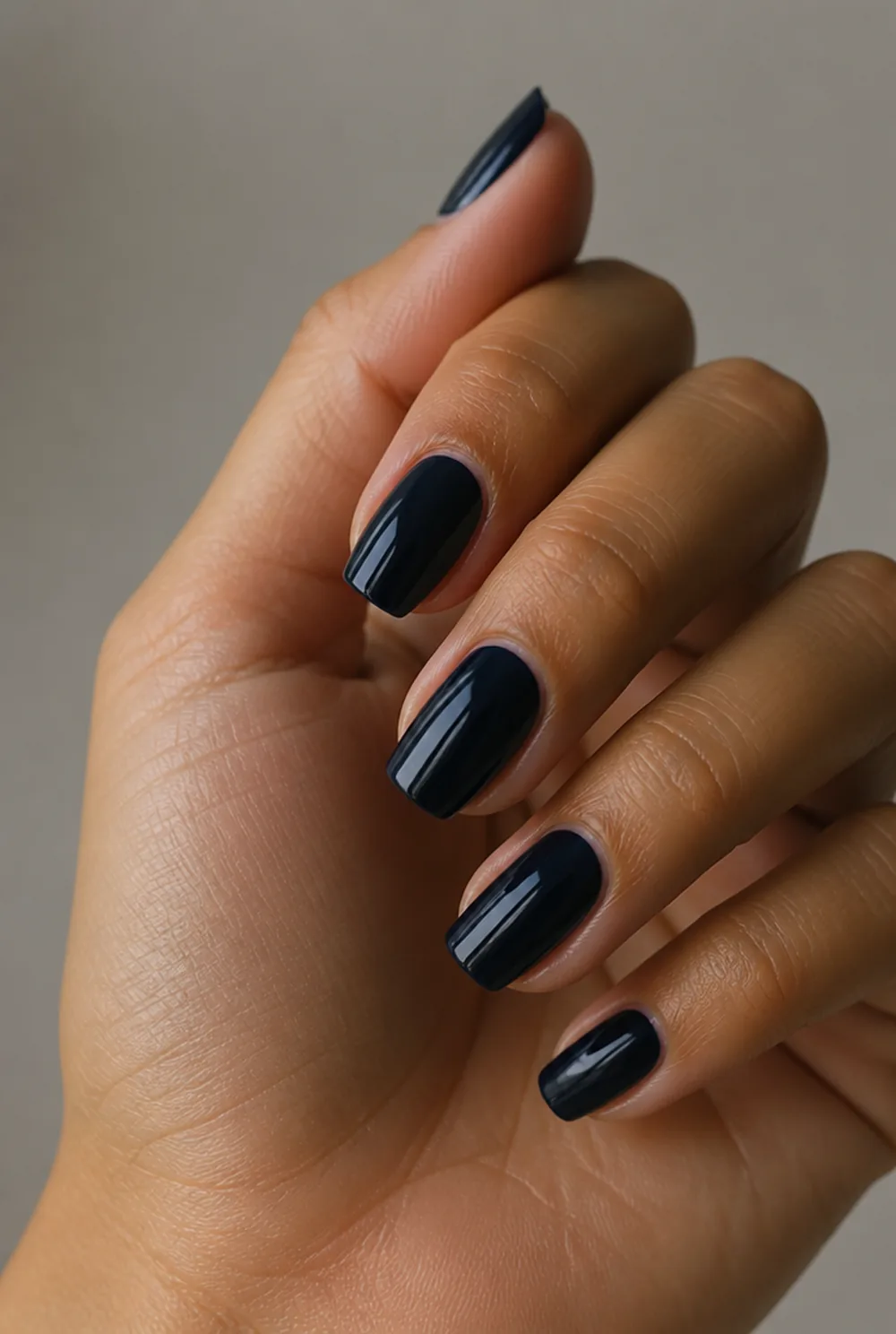 navy almost-black nail art on olive skin, long length