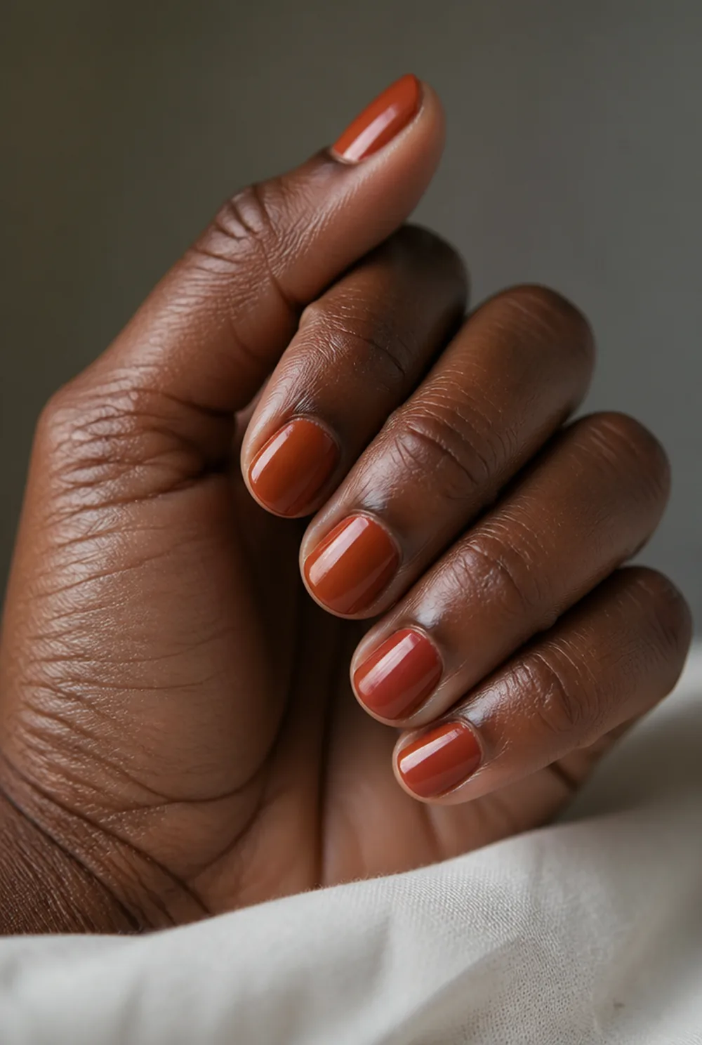 terracotta nail art on deep brown skin