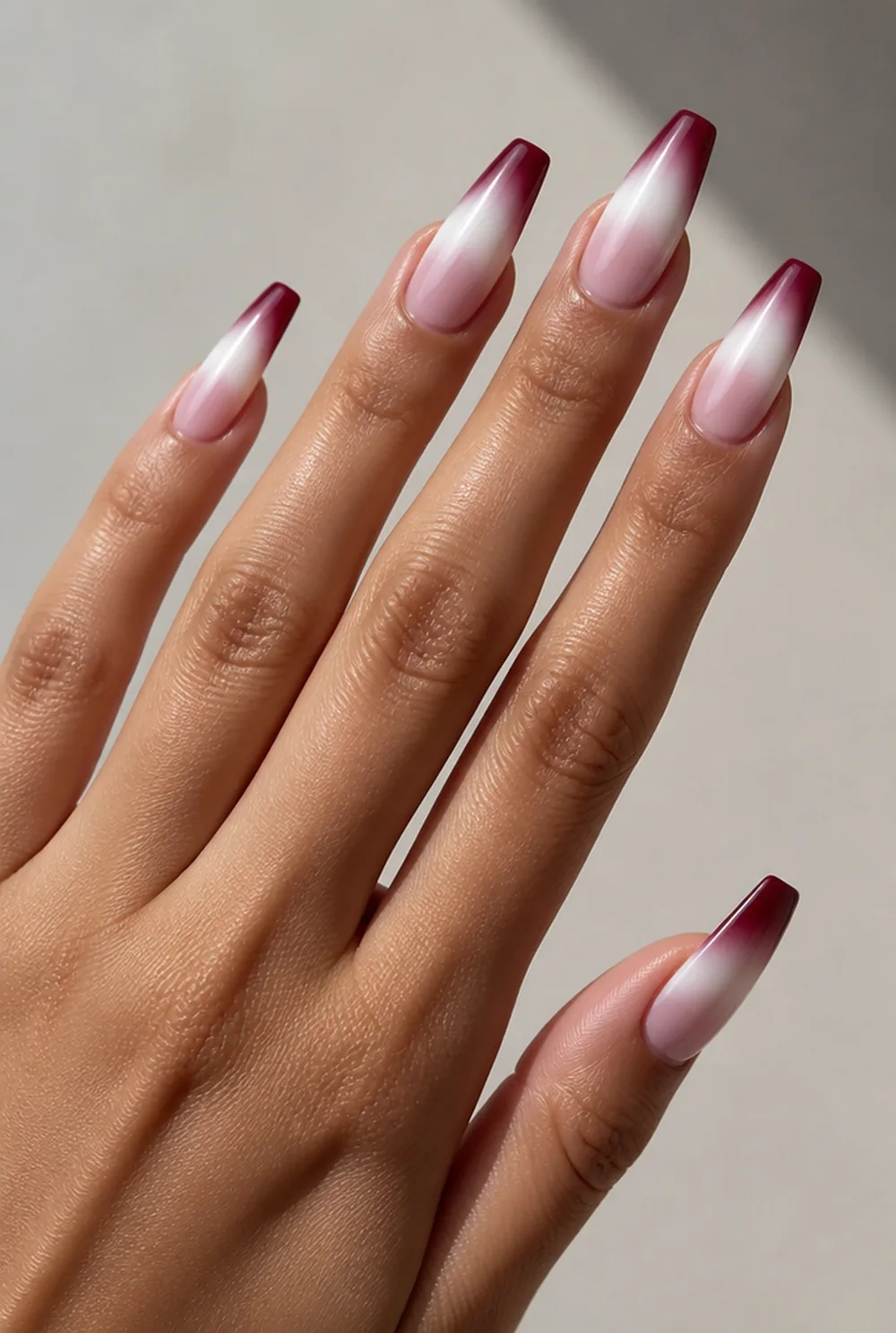 burgundy coffin french nail art on olive skin, long length