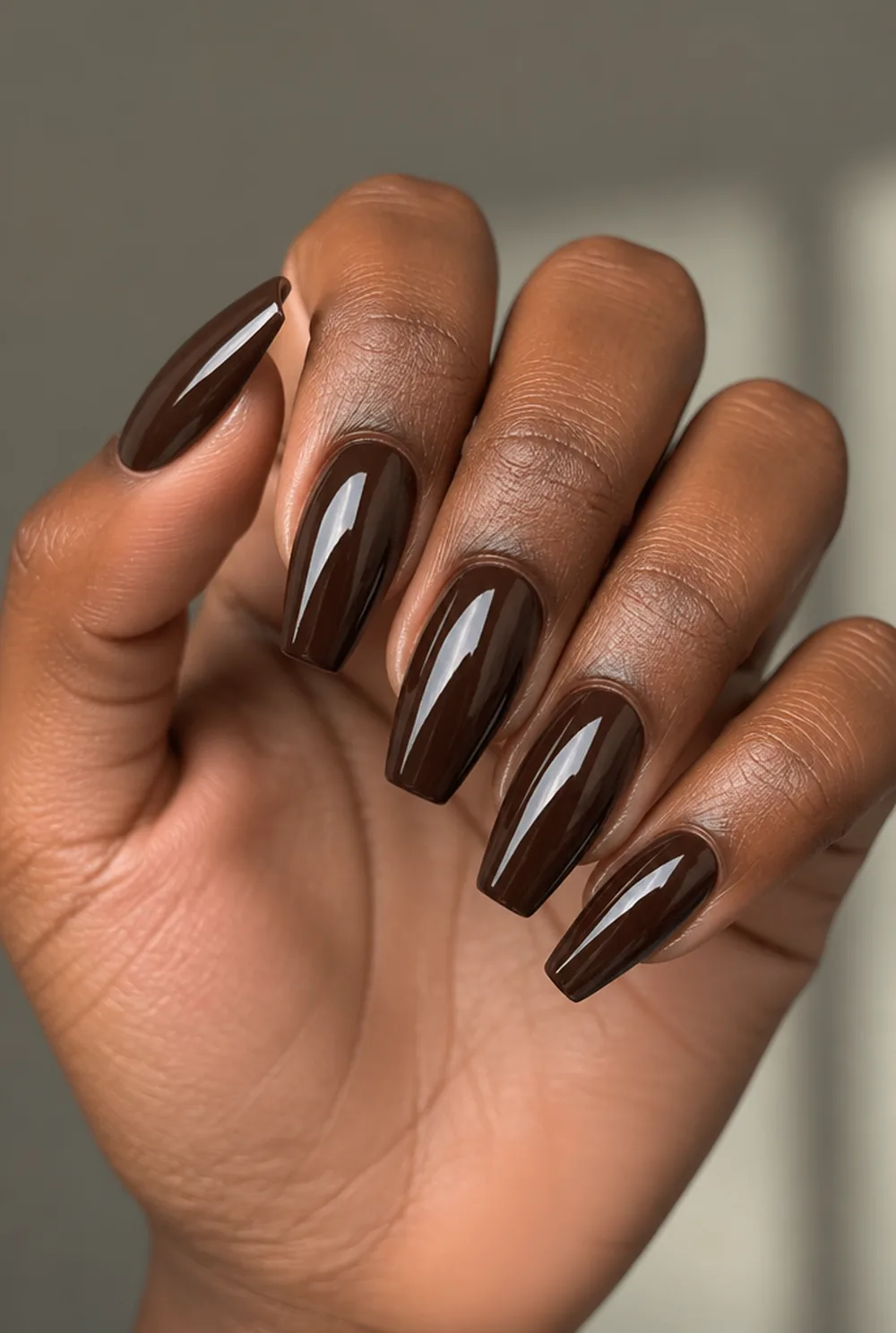 chocolate chrome nail art on deep brown skin