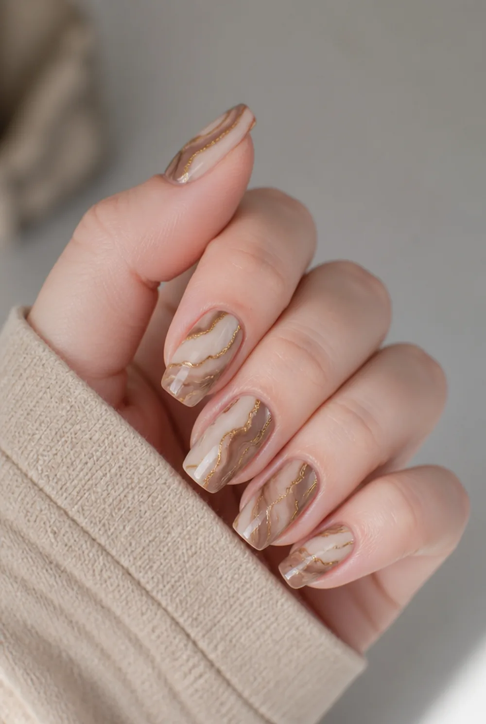 coffee marble nail art on fair skin, short length