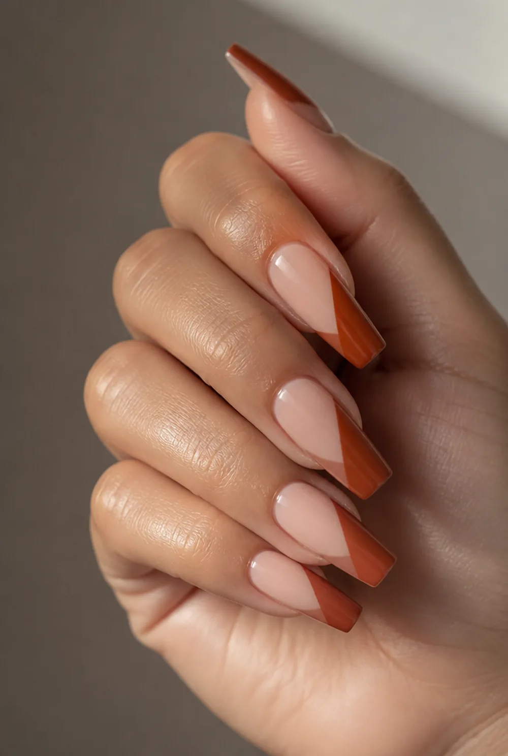 rust color-block nail art on olive skin, long length