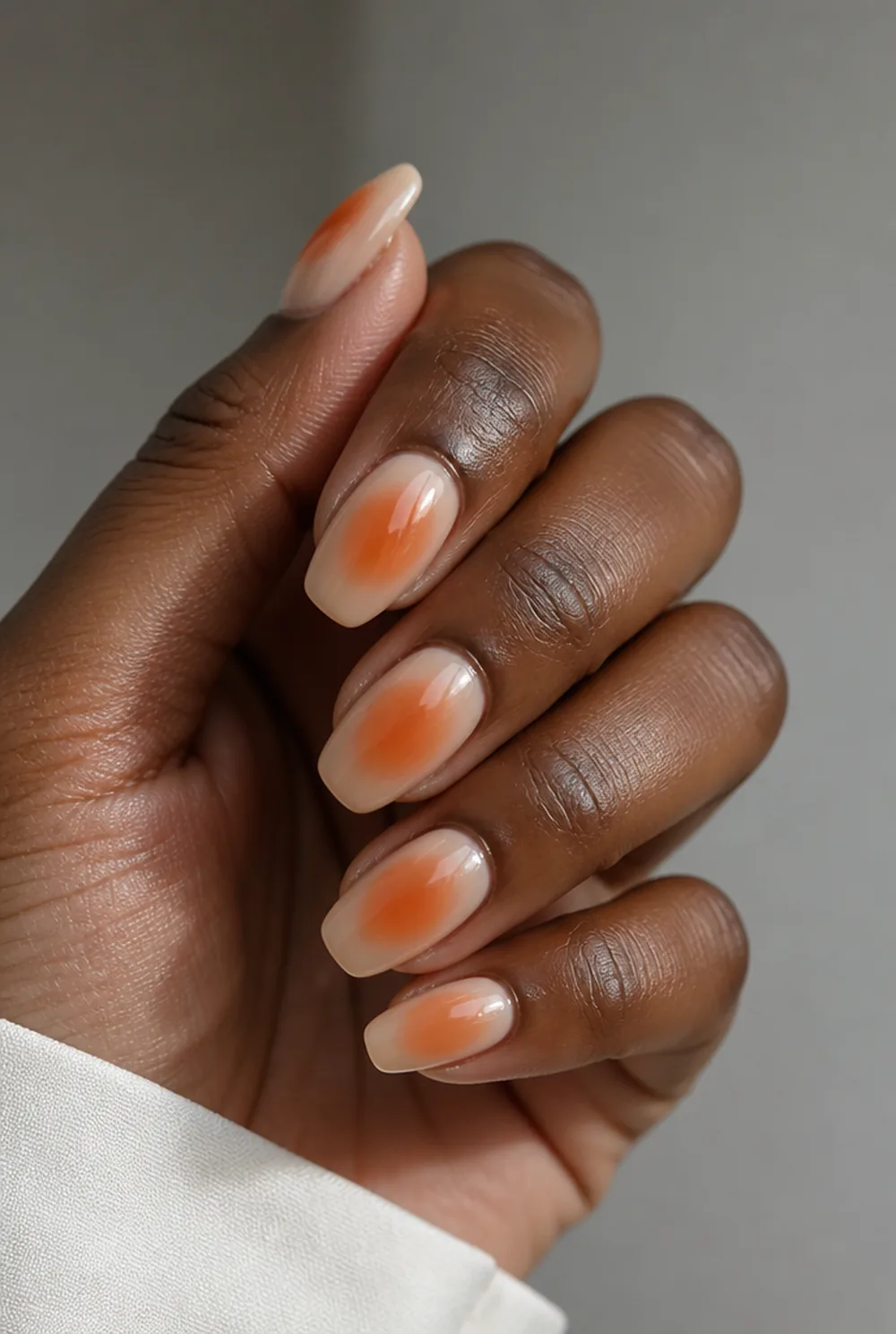 burnt orange aura nail art on deep brown skin
