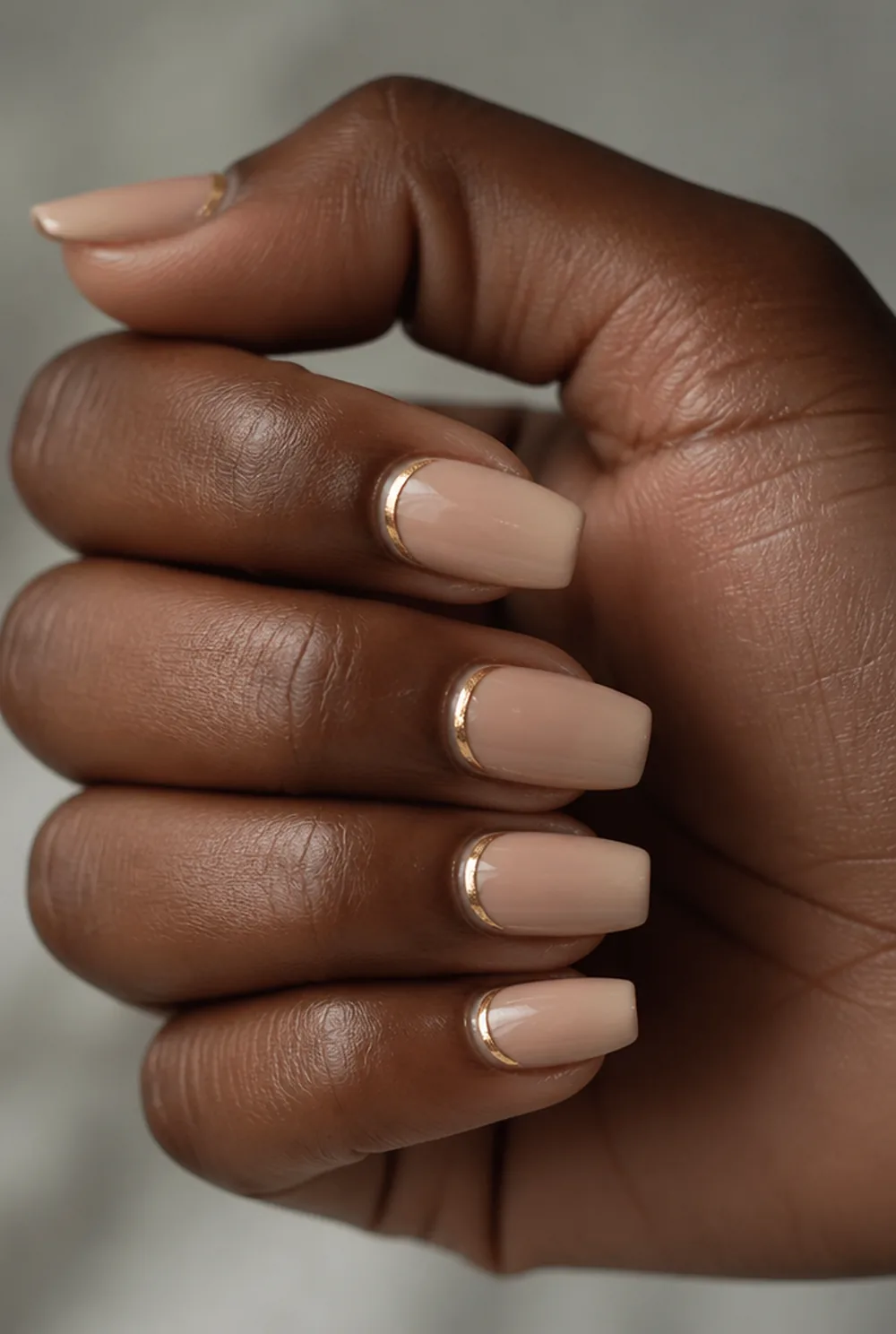 gold cuticle cuffs on nude nail art on deep brown skin