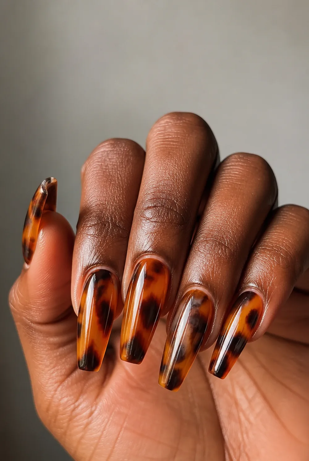 full tortoiseshell set nail art on deep brown skin