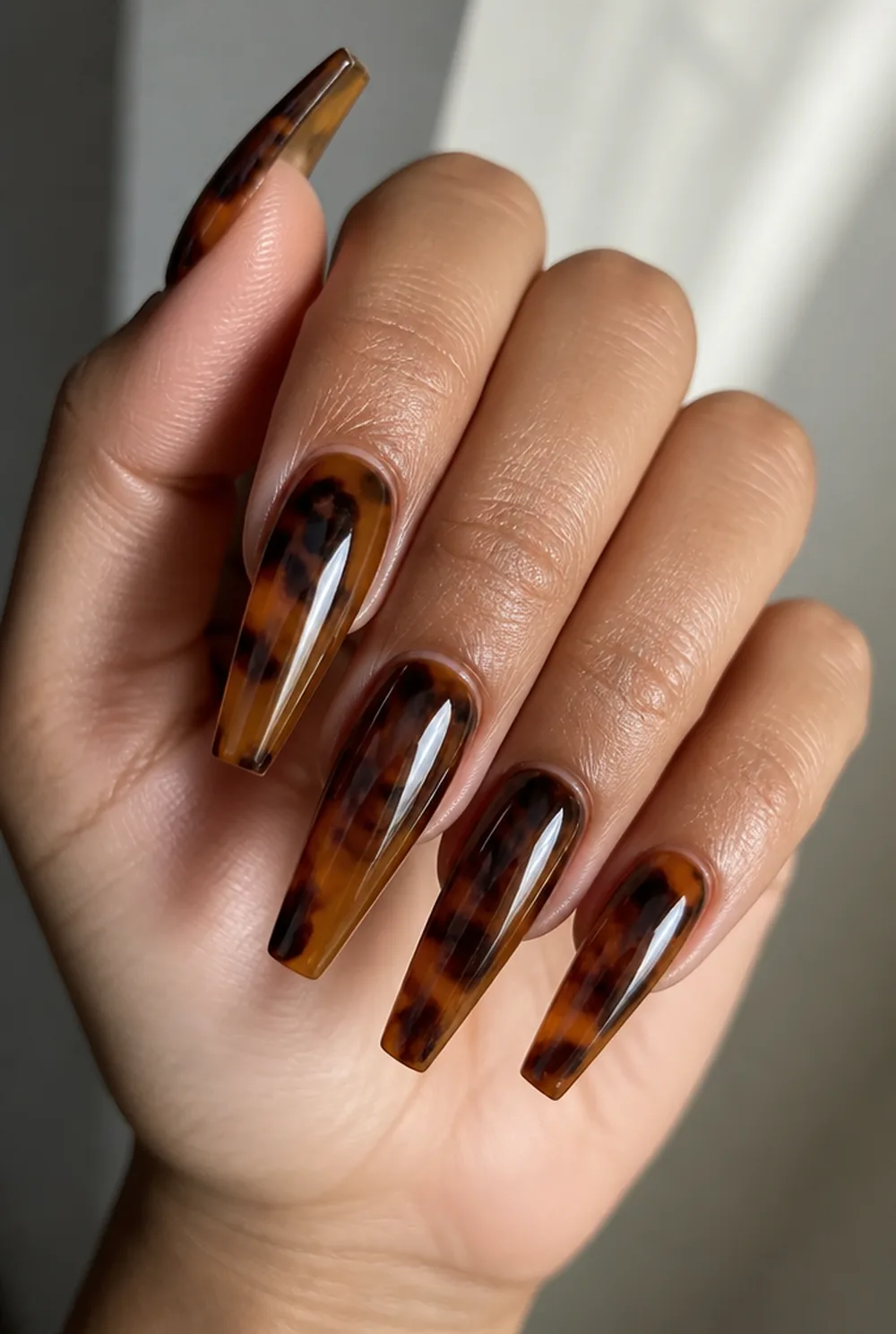 full tortoiseshell set nail art on olive skin, long length