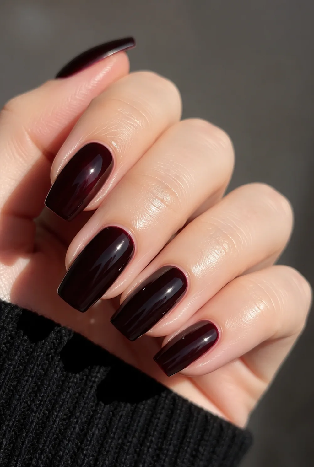 black cherry glass coffin nail art on fair skin, short length