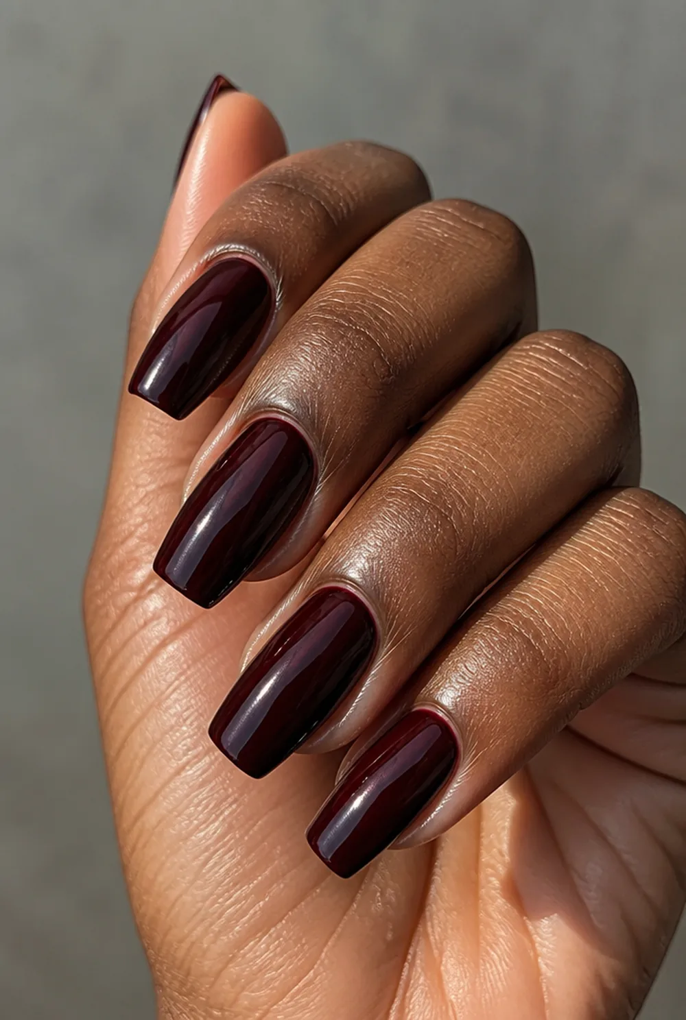 black cherry glass coffin nail art on deep brown skin