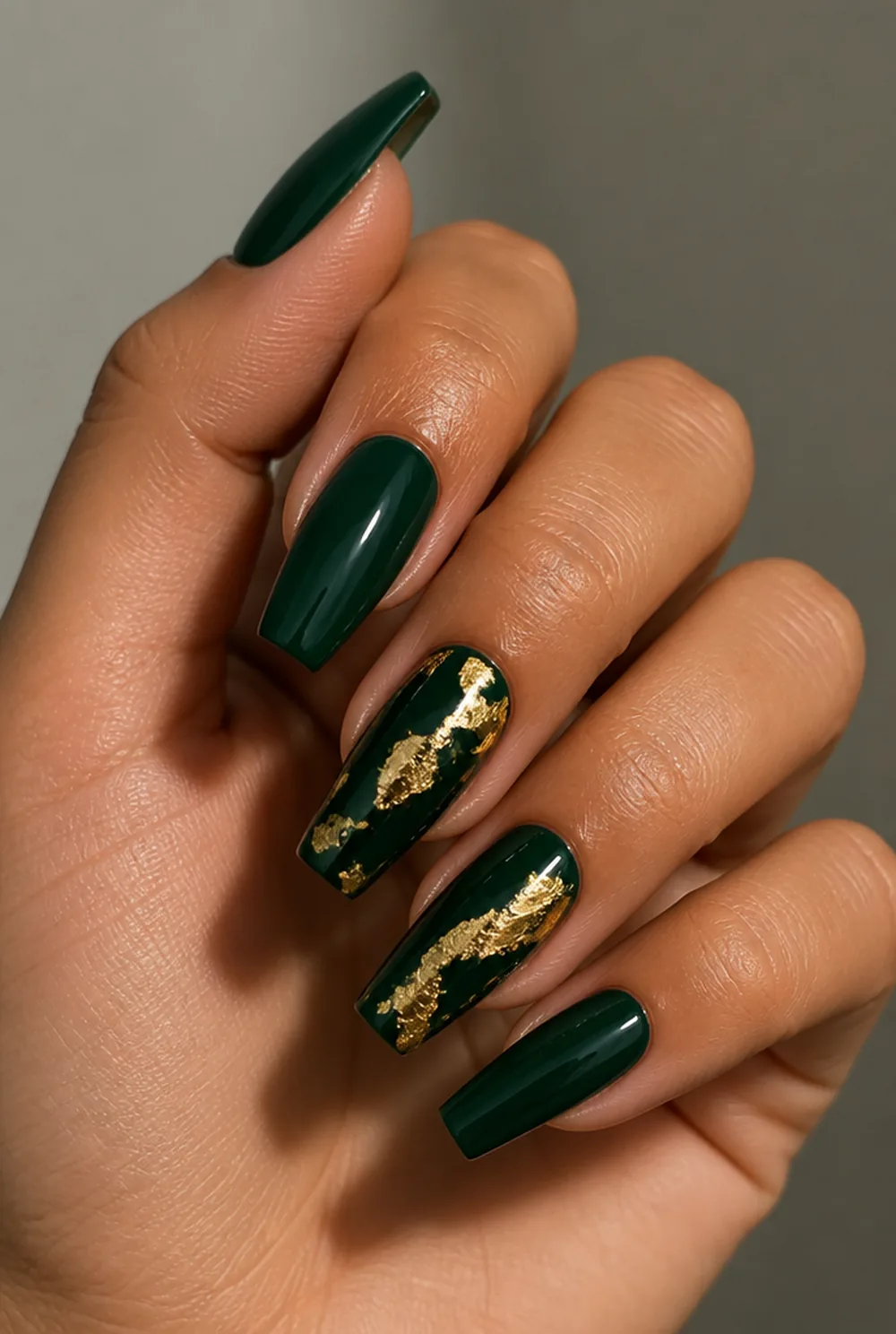 gold foil on emerald nail art on olive skin, long length