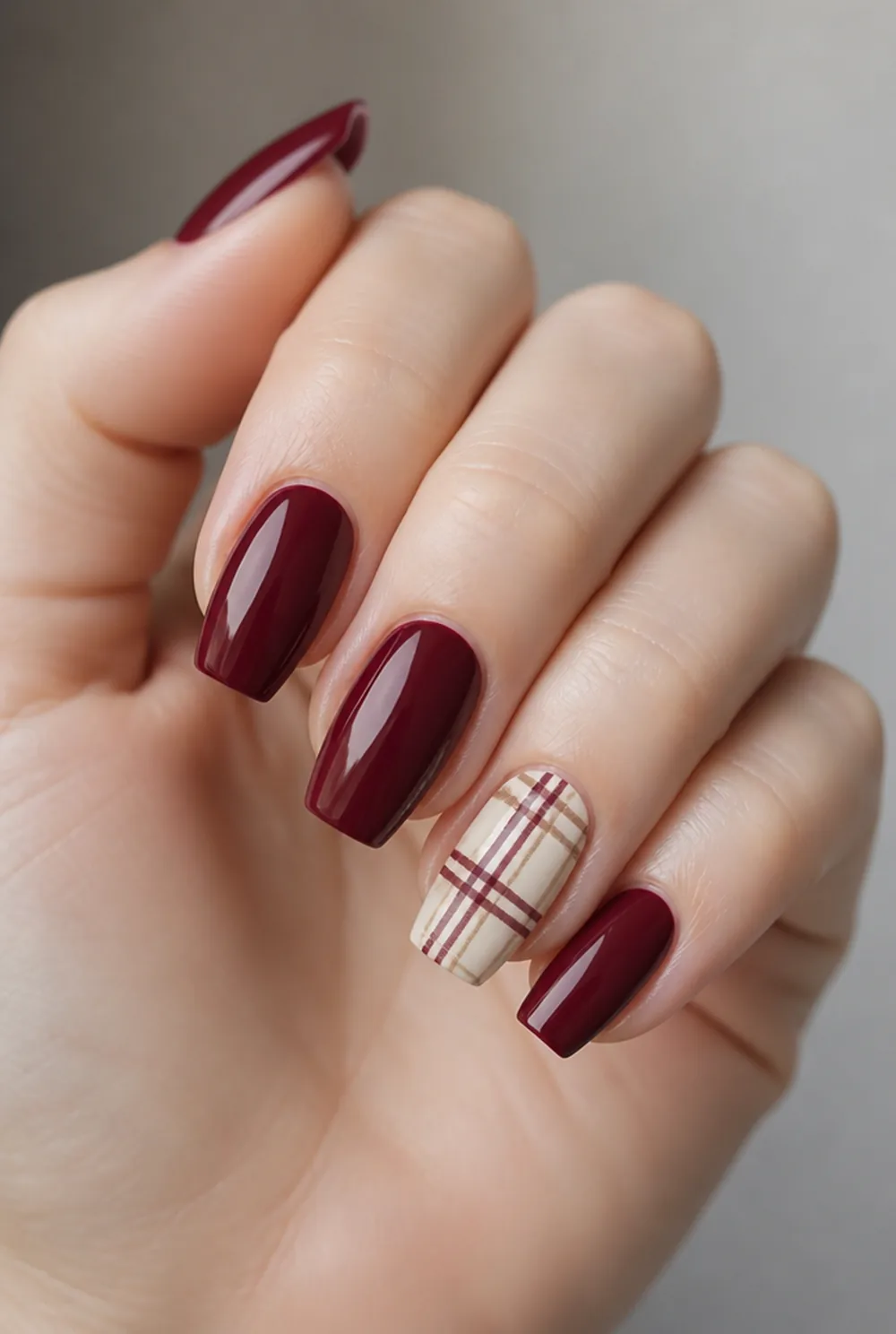 plaid accent coffin nail art on fair skin, short length