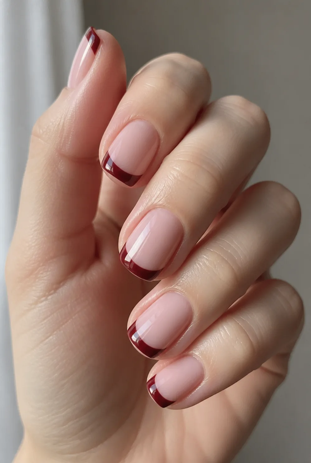 classic burgundy tips nail art on fair skin, short length