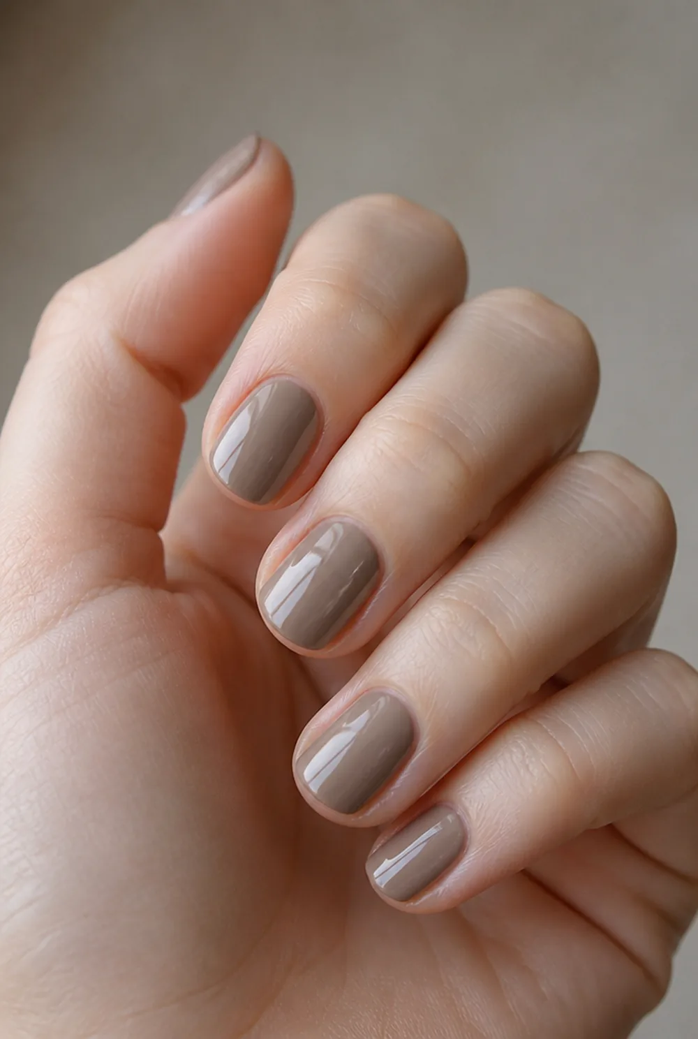 smoked taupe nail art on fair skin, short length
