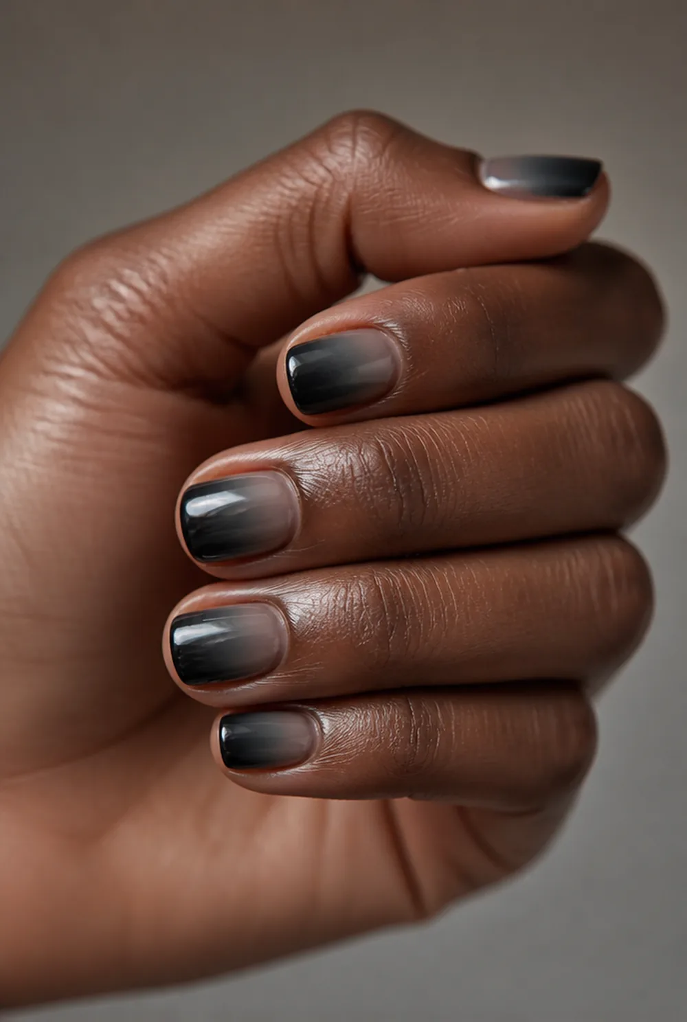 moody smoke nail art on deep brown skin