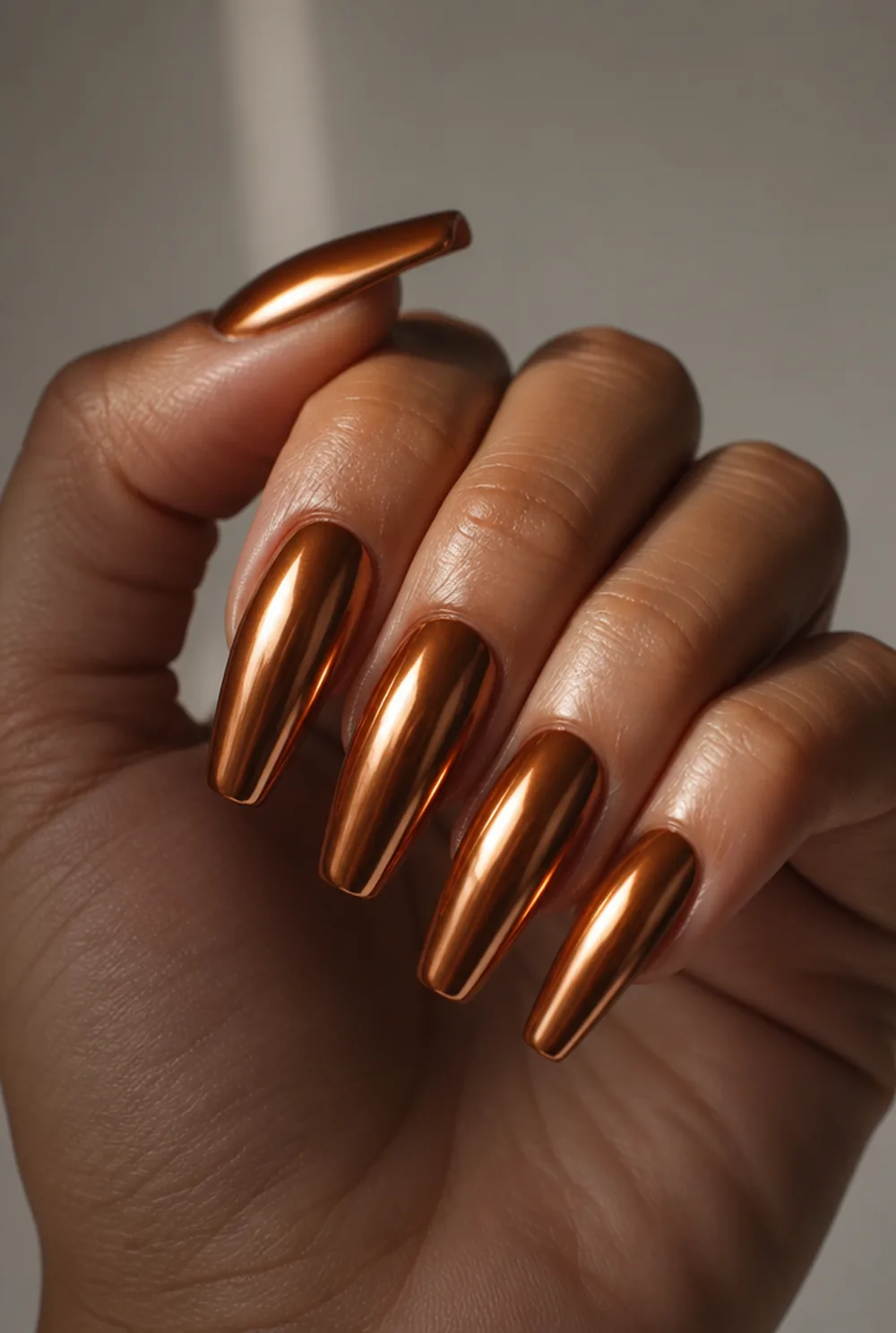 copper chrome nail art on olive skin, long length
