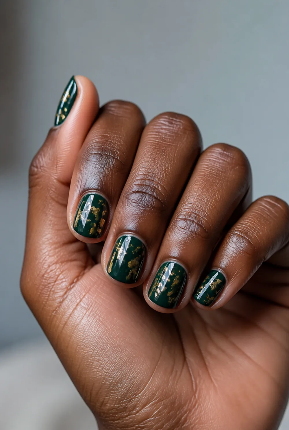 gold foil on deep green nail art on deep brown skin