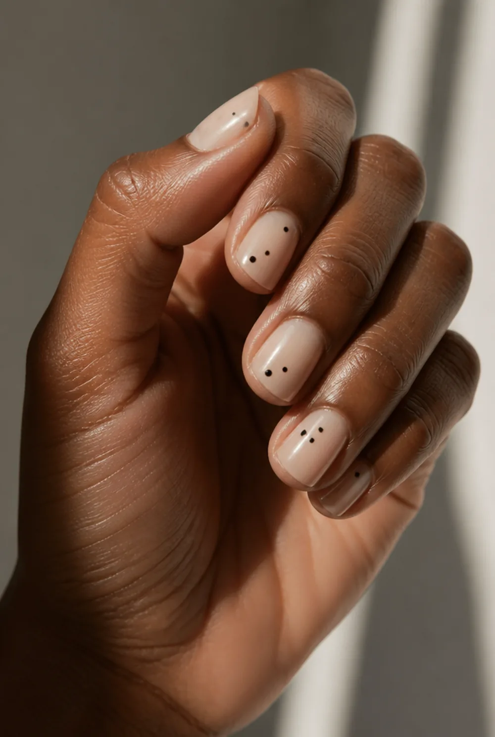 floating dots nail art on deep brown skin